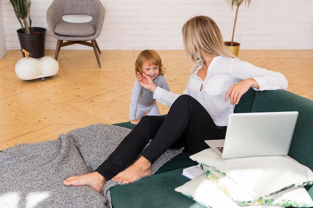 Full shot mother and girl at home