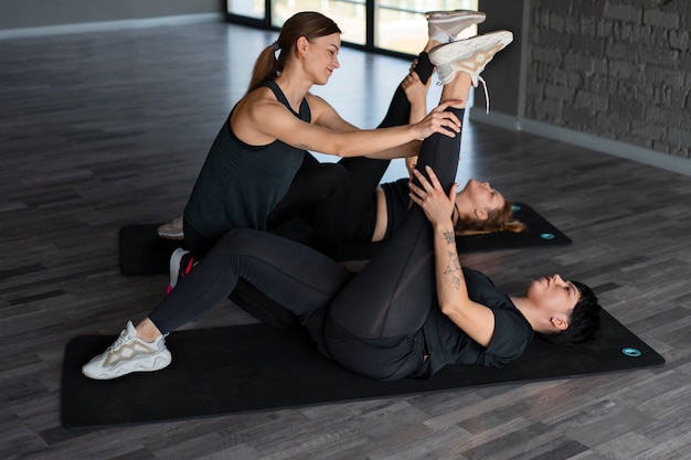 Full shot people in barre group class