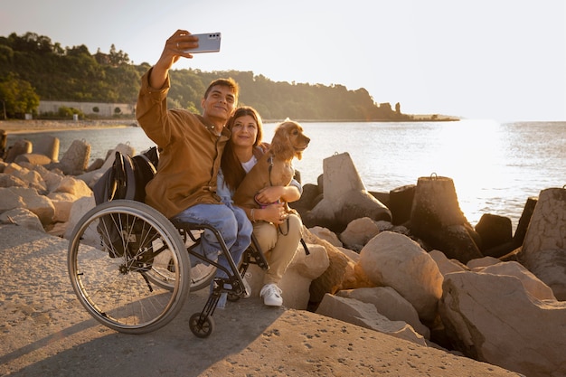 Full shot people taking selfie with dog