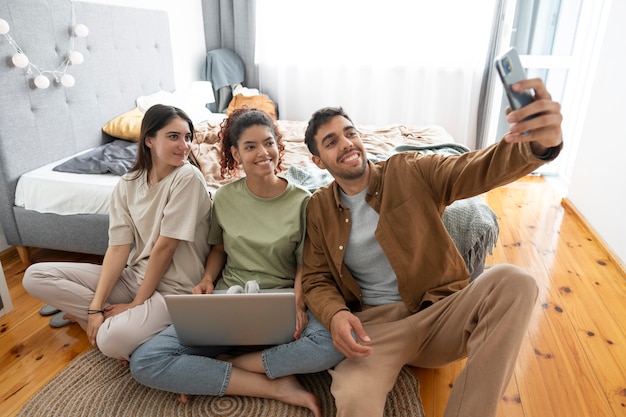 Full shot roommates taking selfie