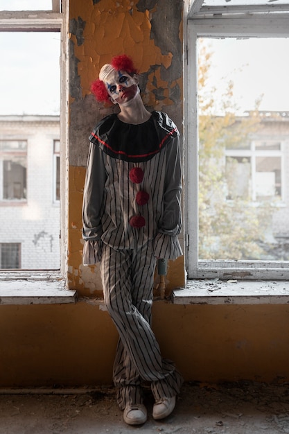 Photo full shot scary clown in abandoned building