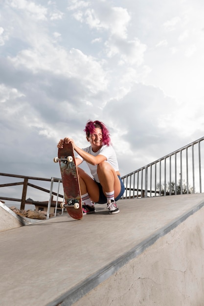 Full shot skater met board in park