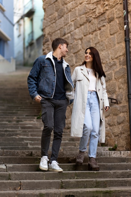 Full shot smiley couple on stairs