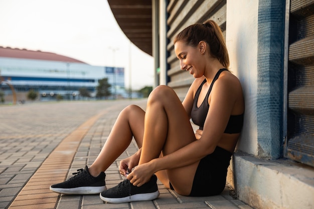 Full shot smiley fit woman outdoors