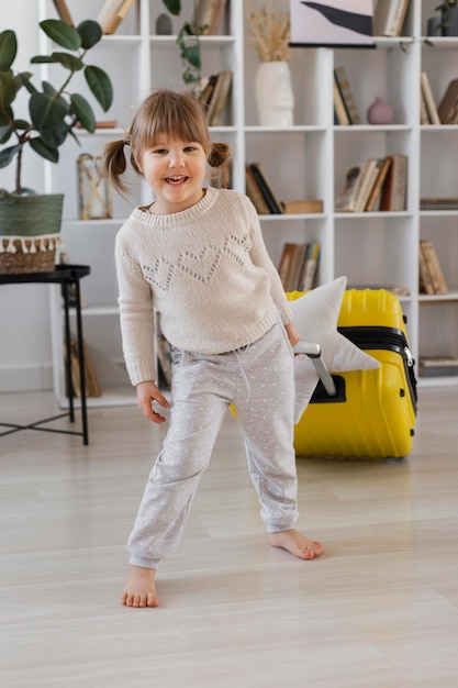 Full shot smiley girl indoors