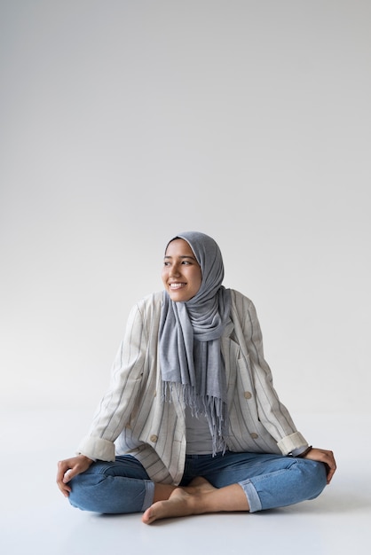 Full shot smiley muslim woman with hijab