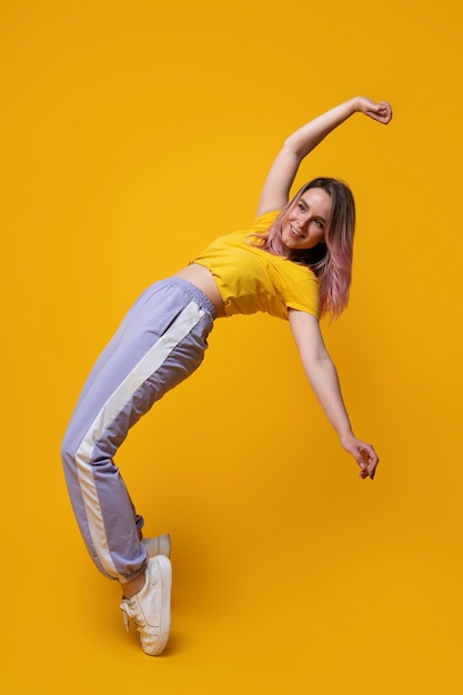 Full shot smiley woman with yellow background