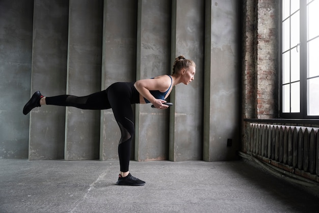 Full shot sporty woman training indoors