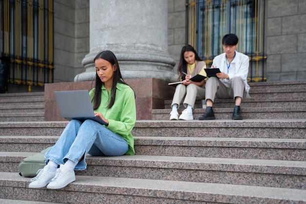 Foto studenti a tutto campo che imparano sulle scale