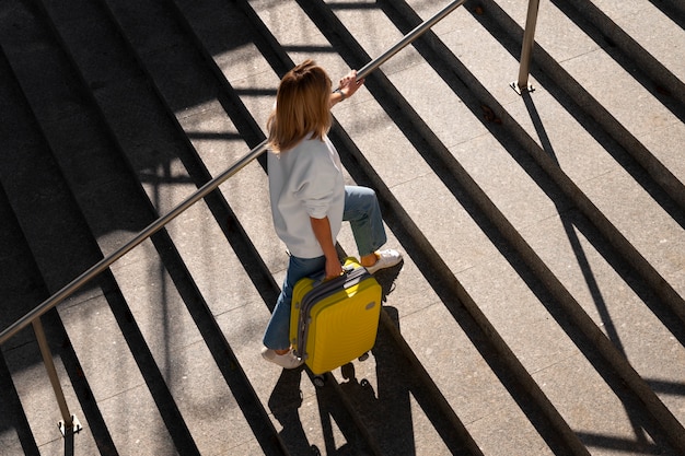 Full shot traveler with suitcase