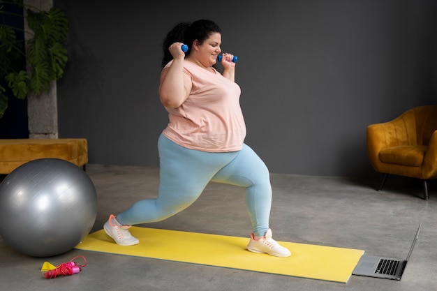 Photo full shot woman exercising at gym