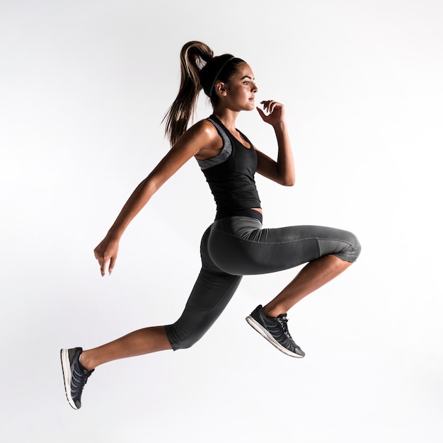 Full shot woman exercising indoors