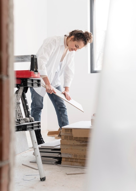 Full shot woman holding board