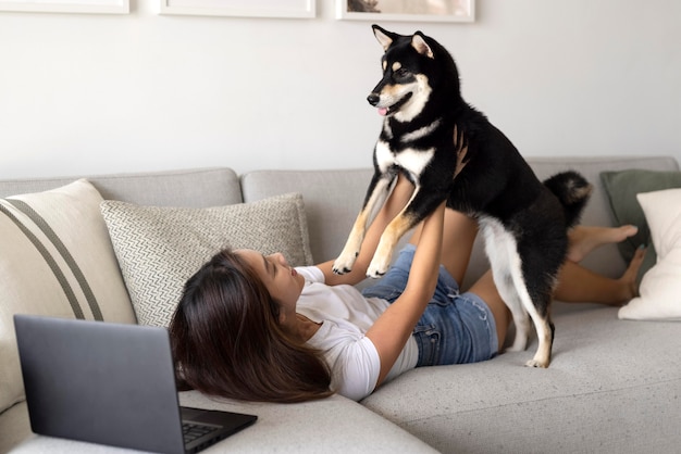 Full shot woman holding dog