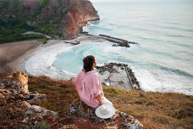 Full shot woman looking at sea