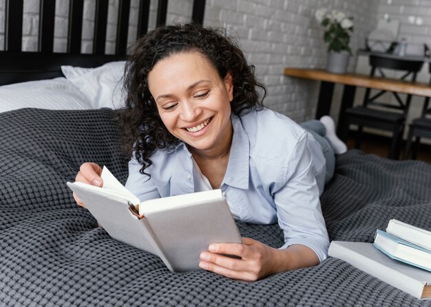 ベッドで読書フルショットの女性