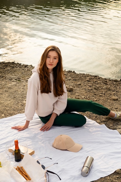 Full shot woman sitting on cloth