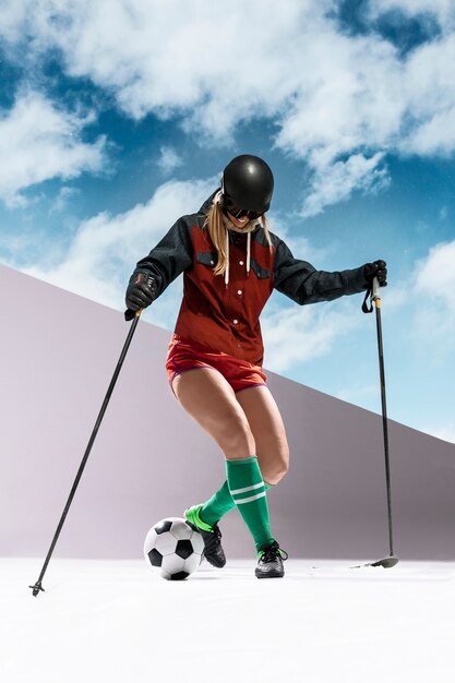 Full shot woman skiing and playing football