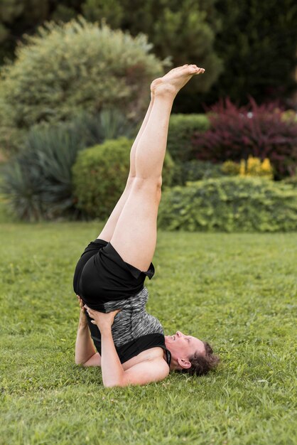 Full shot woman training on grass