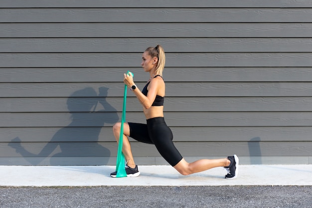 Photo full shot woman training with elastic band