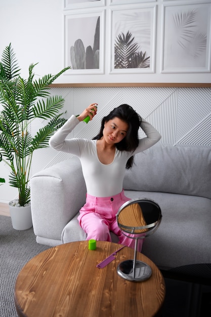 Photo full shot woman using dry shampoo at home