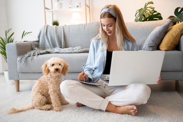 Full shot woman working with cute pet