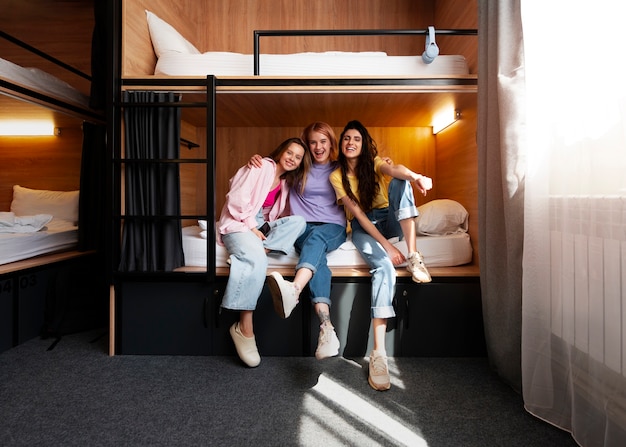 Full shot young women in a hostel