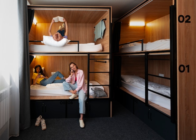 Full shot young women in a hostel