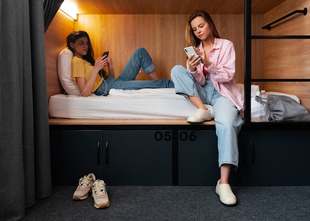 Full shot young women in a hostel