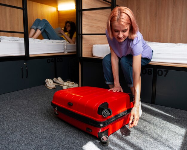 Full shot young women in a hostel