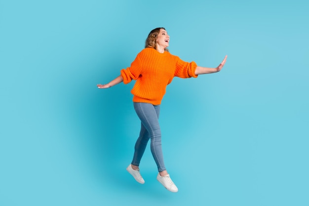 Full size photo of cool millennial lady jump up isolated on green teal color background