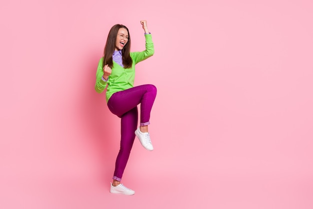 Full size photo of ecstatic girl win raise fists scream isolated over pink color background