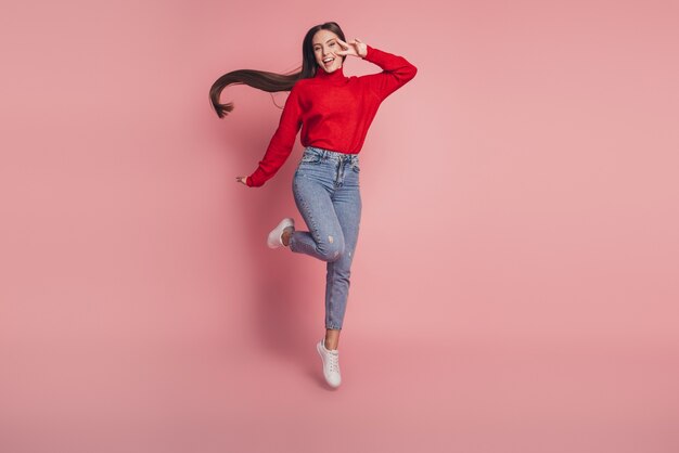 Full size photo of jumping high lady v-signing positively wear casual clothes