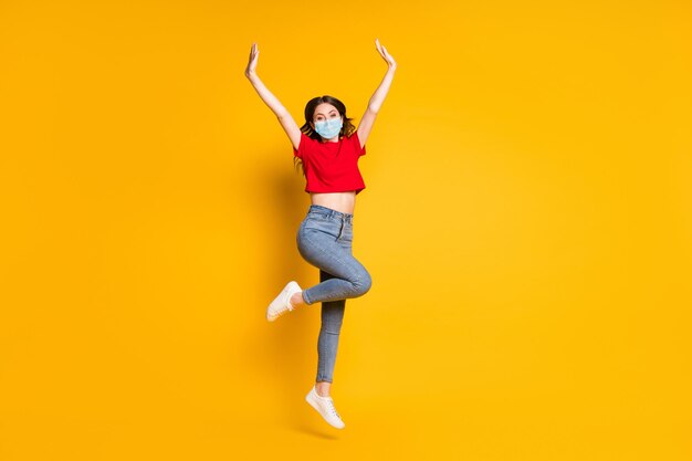 Full size photo of lovely pretty girl jump raise hands wear mask isolated over shine color background