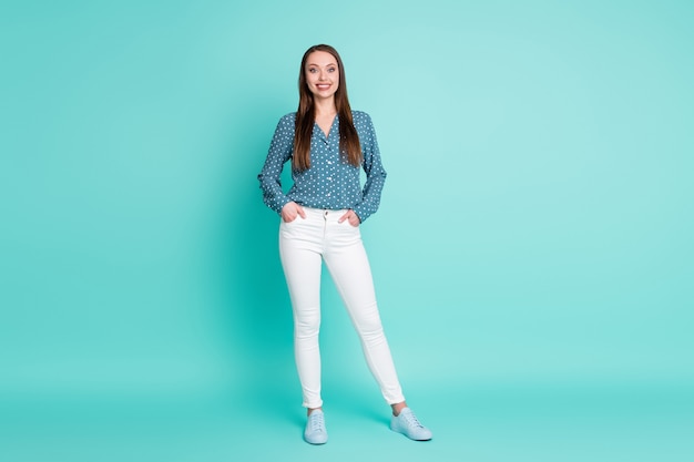 Full size photo of pretty smart lady put hands in pockets stand isolated over turquoise color background