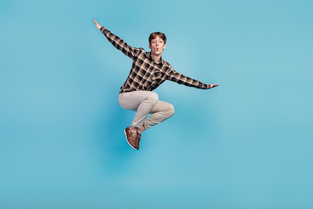 Full size photo of young guy have fun jump up fly air wings wear casual outfit isolated on violet color background