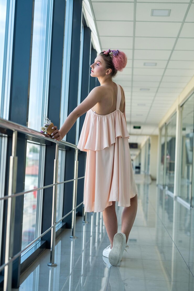 Photo full size photo of young woman in pink dress with flowers