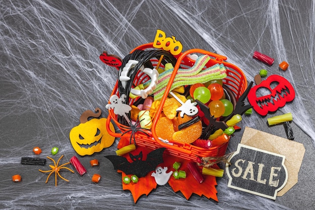 Full of sweets basket sale concept funny halloween background scary spider web traditional fall pumpkins bats and spiders festive dessert classic autumn style top view