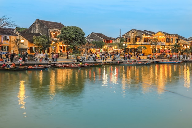 Full of tourists walking on street in Hoi An ancient town at dusk