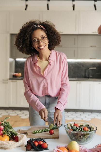 full view of black woman cooking a healthy food