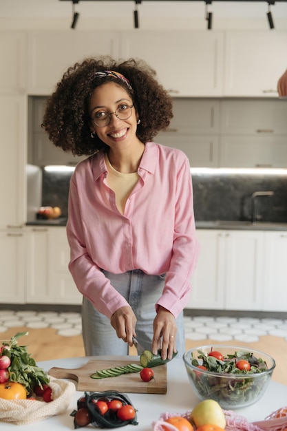 Full view of black woman cooking a healthy food