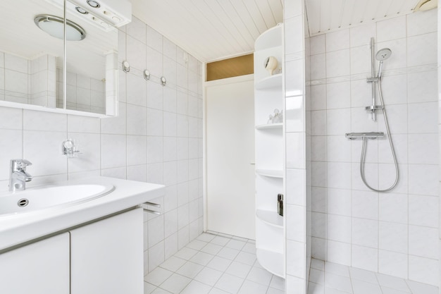 Full white bathroom with bathroom shelves in the corner