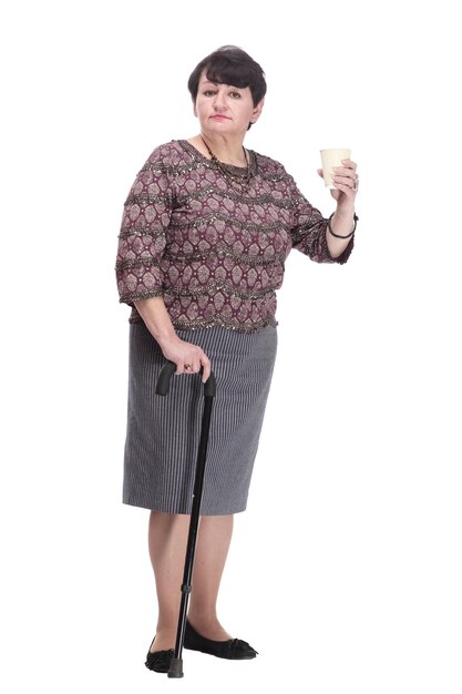 Fulllength casual elderly woman with takeaway coffee