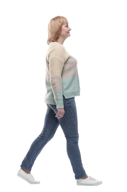 Fulllength casual woman in jeans striding forward