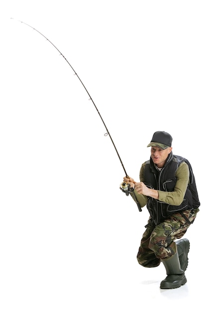 Fulllength portrait of concentrated man with spinner fishing isolated over white background