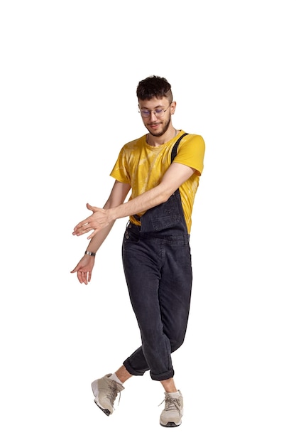 Fulllength portrait of a funny guy dancing in studio isolated on white background