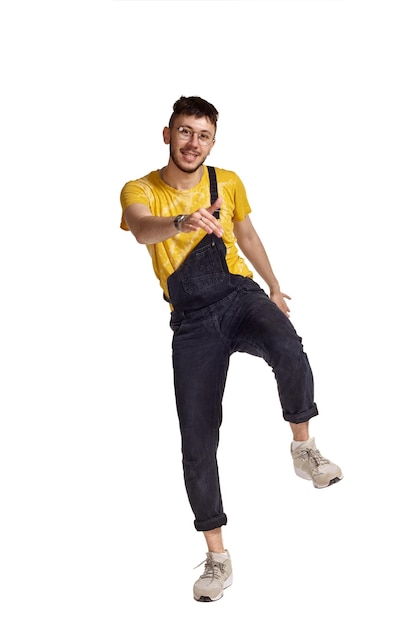 Fulllength portrait of a funny guy dancing in studio isolated on white background