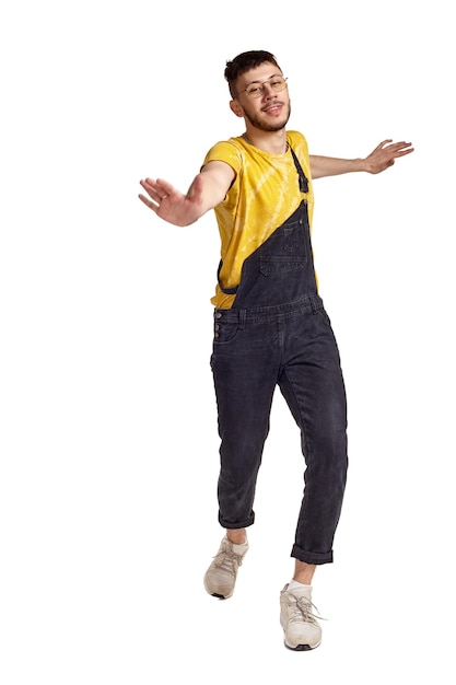 Fulllength portrait of a funny guy dancing in studio isolated on white background