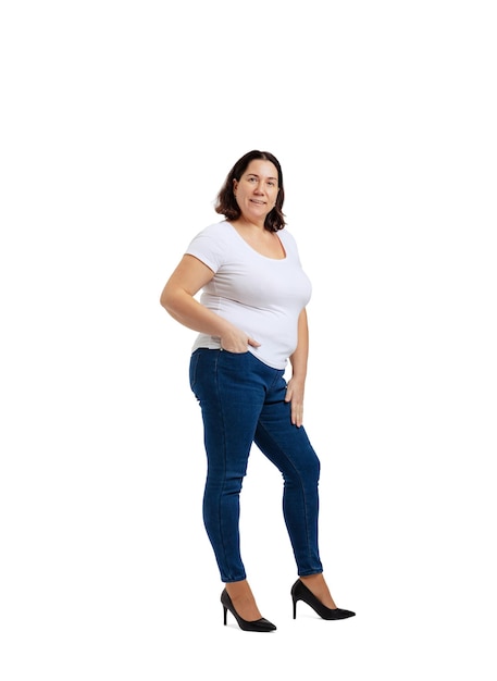 Fulllength portrait of plussize woman wearing white tshirt and jeans posing isolated on white studio