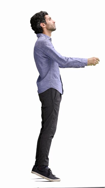 Photo fulllength portrait of a young man standing isolated on white background